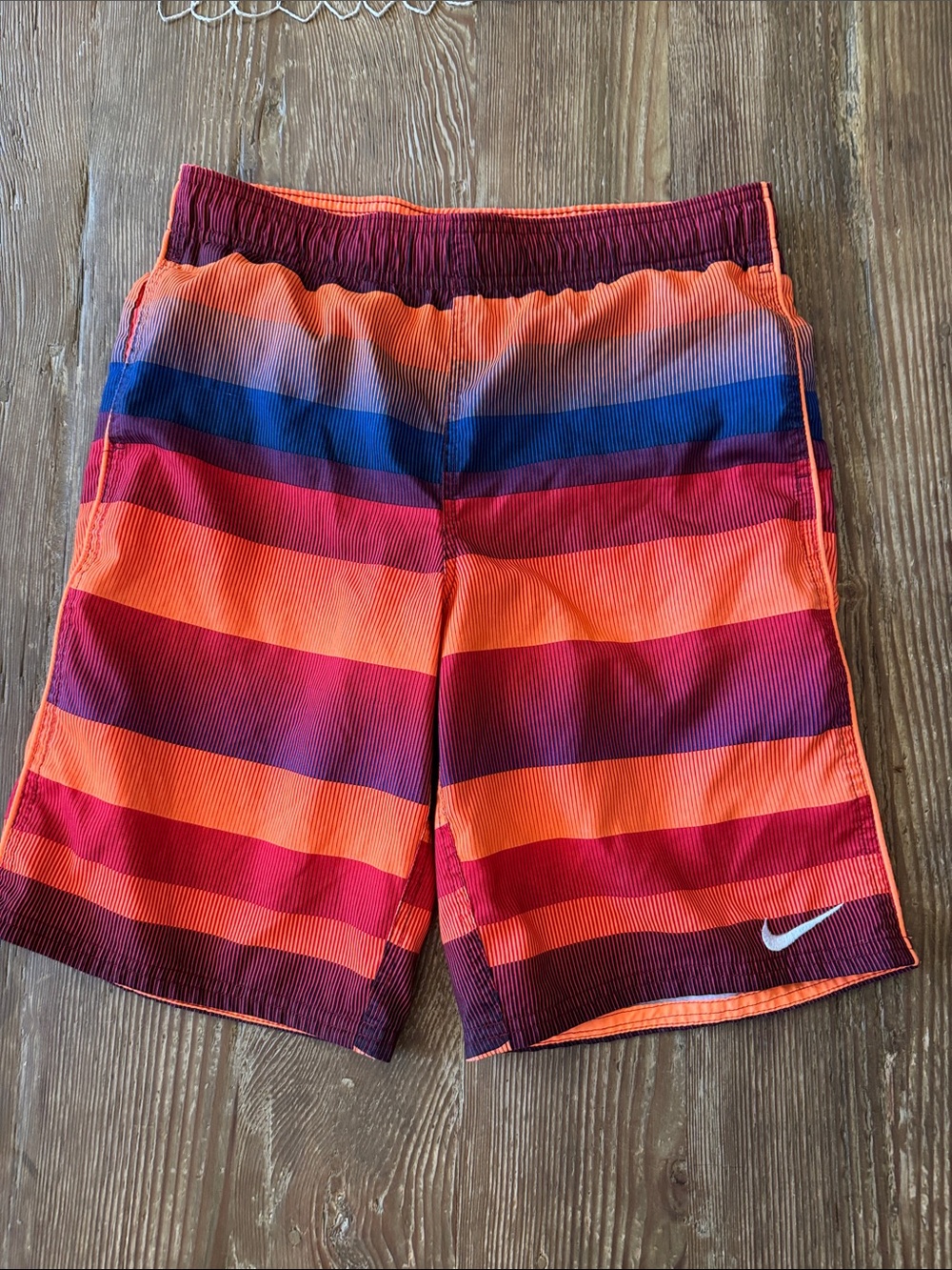 Nike Kids Orange, Red & Blue Striped Swim Trunks but are shorts